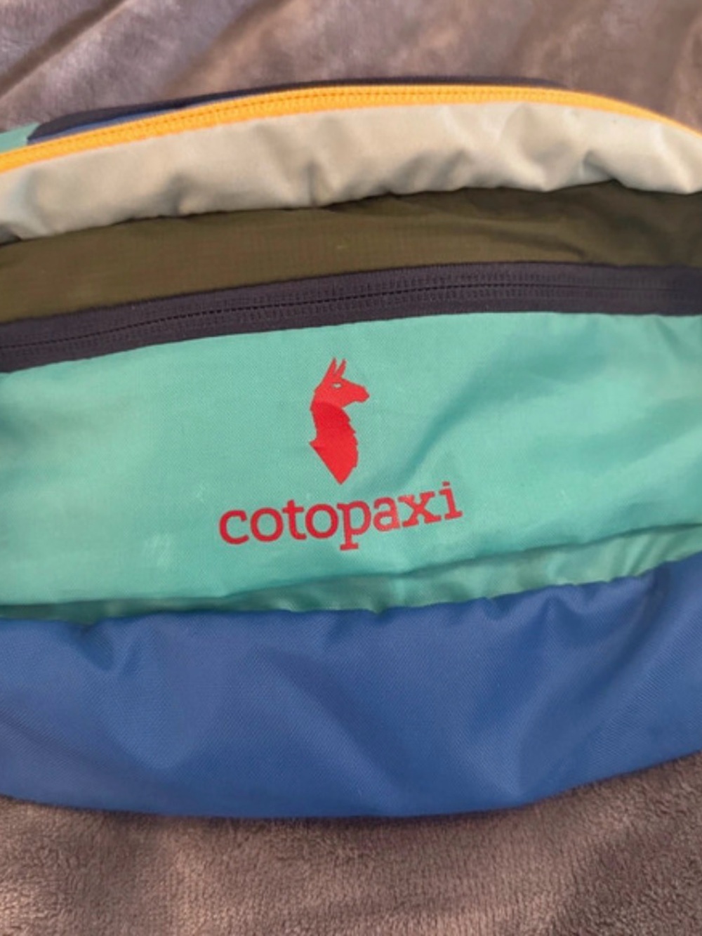 cotopaxi teal aqua blue crossbody bag with red logo